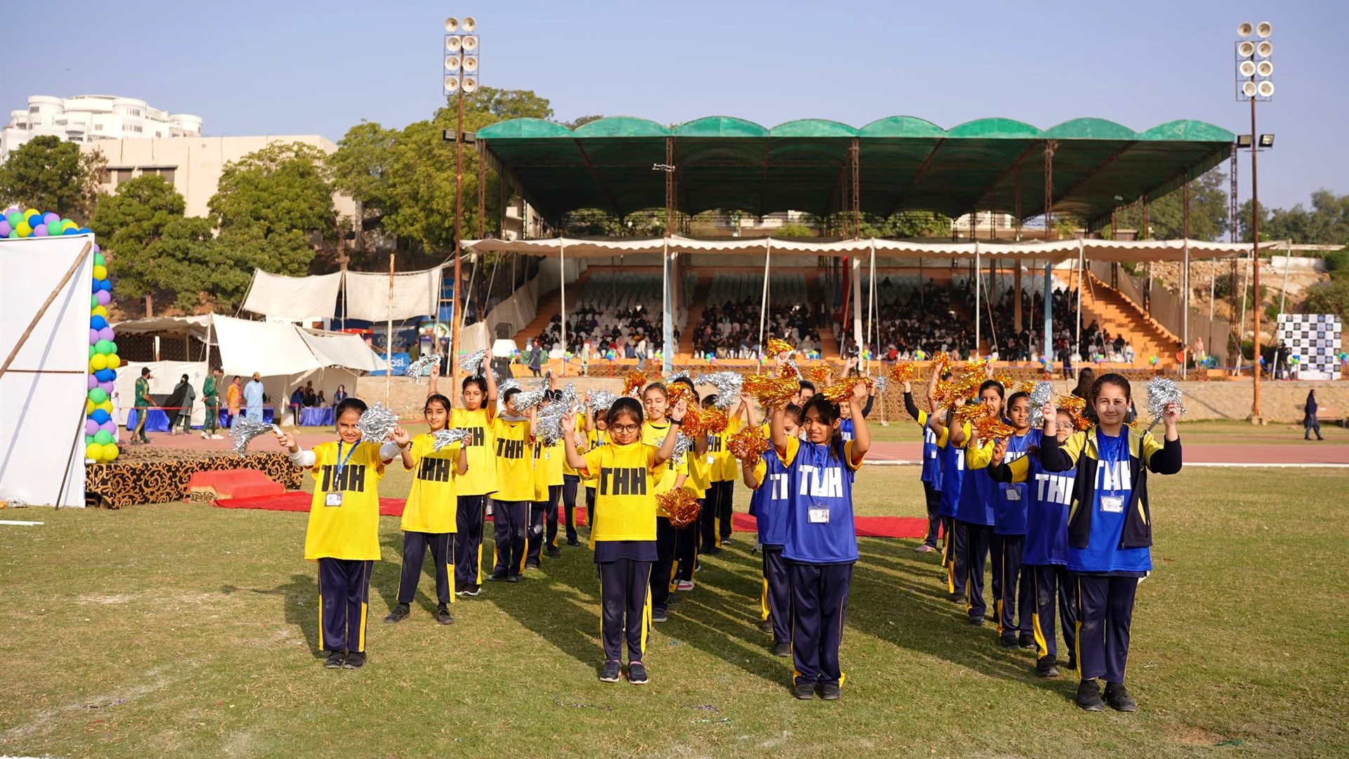 Horizon High students celebrating on sports day in front of a packed grandstand